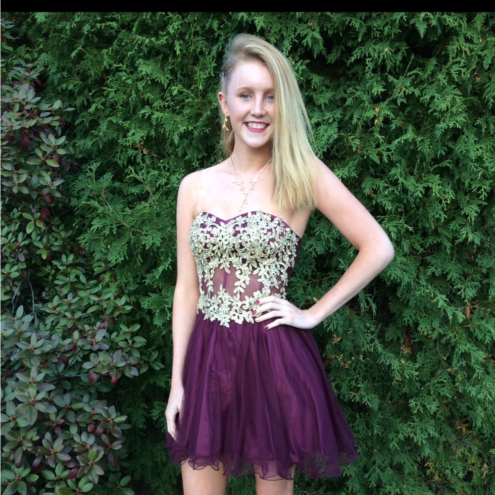 Beautiful maroon corset dress with gold design, perfect for any formal event.